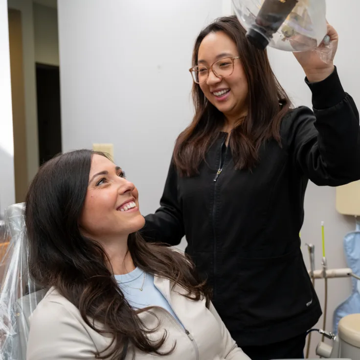 Lumon Dental assistant with a smiling patient in the dental chair